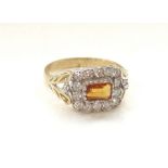 CITRINE AND DIAMOND CLUSTER DRESS RING the central emerald cut citrine in fourteen diamond surround,