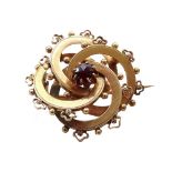 VICTORIAN GARNET SET GOLD BROOCH of entwined circular design,