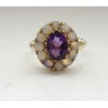 AMETHYST AND OPAL CLUSTER DRESS RING the central oval cut amethyst in twelve round cabochon opal