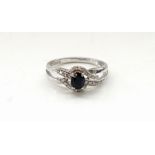 SAPPHIRE AND DIAMOND RING the central oval cut sapphire in multi diamond surround,