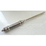 CONTINENTAL SILVER TAPER STICK with a turned handle decorated with flower heads within lozenges
