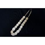 GRADUATED BONE DISC NECKLACE with seventeen disks below twenty four bone beads,