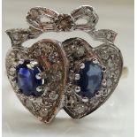 UNUSUAL SAPPHIRE AND DIAMOND RING in the form of two hearts surmounted by a bow,