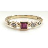 RUBY AND DIAMOND RING the central square cut ruby flanked by a small diamond to each shoulder,