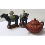 PAIR OF CHINESE POTTERY INCENSE BURNERS modelled as elephants with an urn on there backs,