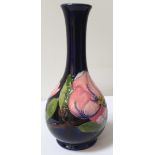 MOORCROFT POTTERY PEAR SHAPED VASE decorated in the hibiscus pattern with a blue ground,