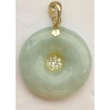 CHINESE JADE DISC PENDANT mounted in fourteen carat gold,