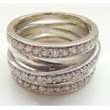 UNUSUAL DIAMOND CLUSTER RING the diamonds set in three rows with a diagonal band below creating a