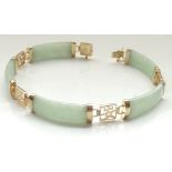 JADE AND NINE CARAT GOLD BRACELET with alternating jade panels and pierced gold squares with