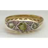 PERIDOT AND DIAMOND RING the three graduated peridots separated by small diamonds,