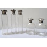 SET OF FIVE GEORGE V SILVER TOPPED DRESSING TABLE BOTTLES comprising two squat bottles and three