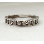 DIAMOND NINE STONE HALF ETERNITY RING the illusion set diamonds in nine carat white gold shank,