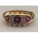 RUBY AND DIAMOND CLUSTER RING on nine carat gold shank,