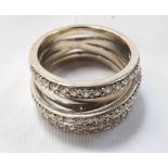 UNUSUAL DIAMOND CLUSTER RING the diamonds set in three rows with a diagonal band below creating a