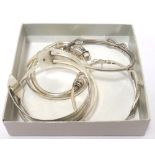 SIX SILVER BANGLES of various sizes and designs including one set with a CZ infinity symbol and