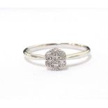 DIAMOND CLUSTER RING in illusion setting, on nine carat white gold shank,