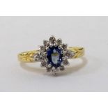 SAPPHIRE AND DIAMOND CLUSTER RING the central oval cut sapphire in twelve diamond surround