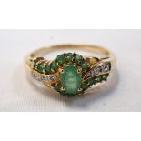 EMERALD AND DIAMOND CLUSTER DRESS RING on unmarked gold shank,