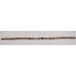 UNUSUAL MULTI COLOURED SAPPHIRE LINE BRACELET the twelve round cut sapphires separated by pierced