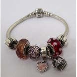 PANDORA MOMENTS SILVER CHARM BRACELET with five Pandora charms and two Pandora clips