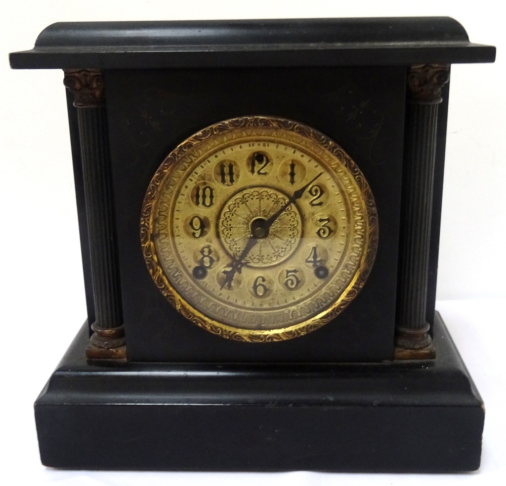 19th CENTURY AMERICAN BLACK SLATE EFFECT MANTEL CLOCK the circular gilt face with Arabic numerals,