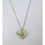 CLOGAU CALON LAN SILVER HEART SHAPED LOCKET PENDANT with a small central diamond set rose gold