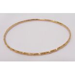 UNMARKED HIGH CARAT GOLD BANGLE with cut decoration,