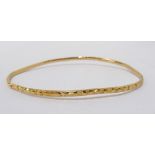 UNMARKED HIGH CARAT GOLD BANGLE with cut decoration, approximately 8.