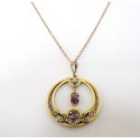 EDWARDIAN AMETHYST AND SEED PEARL PENDANT in unmarked gold and on nine carat gold chain