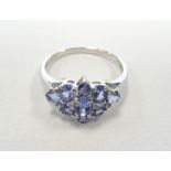 TANZANITE AND DIAMOND CLUSTER DRESS RING the graduated oval and round cut tanzanites interspersed
