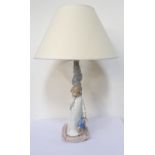 'NAO' FIGURAL TABLE LAMP with a young girl in nightgown holding a toy clown,