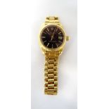 LADIES EIGHTEEN CARAT GOLD ROLEX OYSTER PERPETUAL DATEJUST WRISTWATCH the black dial with baton