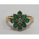 EMERALD AND DIAMOND CLUSTER RING on nine carat gold shank,