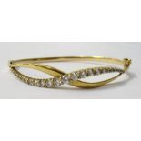 CZ SET UNMARKED GOLD BANGLE the graduated CZ gemstones to the pierced twist frontispiece,