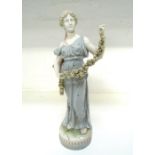 ROYAL DUX PORCELAIN FIGURINE of a classical lady holding a garland of flowers,