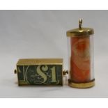 TWO NINE CARAT GOLD MOUNTED CHARMS one containing a £1 note engraved 'In Emergency Break Glass';