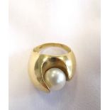 UNUSUAL PEARL SET DRESS RING in fourteen carat gold shaped setting, ring size M,