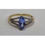 ATTRACTIVE TANZANITE AND DIAMOND DRESS RING the central marquise cut tanzanite approximately 0.