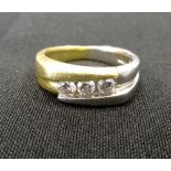 DIAMOND THREE STONE RING the channel set diamonds totalling approximately 0.