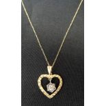 DIAMOND SET HEART PENDANT the floral design diamond cluster suspended in the centre of the heart,