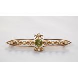 EDWARDIAN PERIDOT AND SEED PEARL BROOCH in unmarked high carat gold pierced setting, 4.