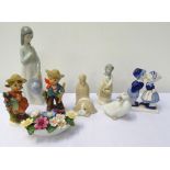 SELECTION OF FIGURINES including a Nao girl holding a posy of flowers to her chest,