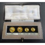 BOXED NINE CARAT GOLD STUD SET the four graduated studs in fitted box with identifying label below