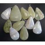 SELECTION OF GREEN MARBLE AND HARDSTONE PENDANTS of various sizes,