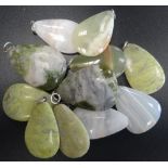 SELECTION OF GREEN MARBLE AND HARDSTONE PENDANTS of various sizes,