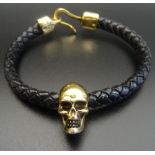 ALEXANDER McQUEEN SKULL LEATHER BRACELET the brass skull on a plaited leather bracelet,