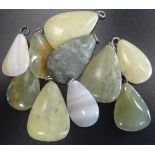 SELECTION OF GREEN MARBLE AND HARDSTONE PENDANTS of various sizes,