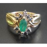 EMERALD AND DIAMOND CLUSTER DRESS RING the central marquise cut emerald in diamond surround,