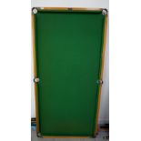 JOE DAVIS TABLE TOP BILLIARDS TABLE with a green baize lined top, 185cm x 93cm, with two cues,