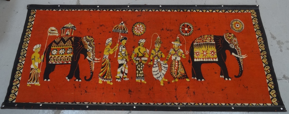LARGE BATIK WALL HANGING depicting a Sri Lankan parade with elephants, mounted on wooden strips,